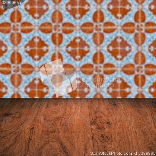 Image of Wood table top and blur vintage ceramic tile pattern wall