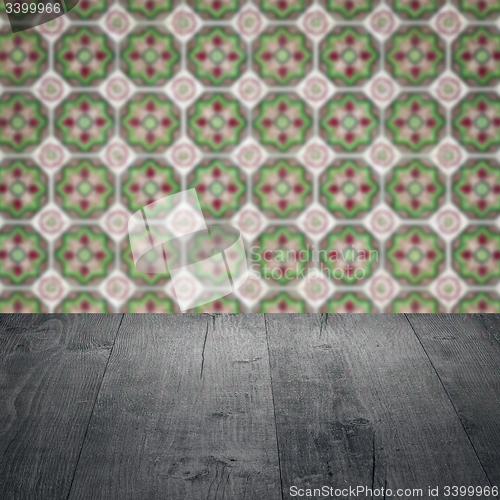 Image of Wood table top and blur vintage ceramic tile pattern wall