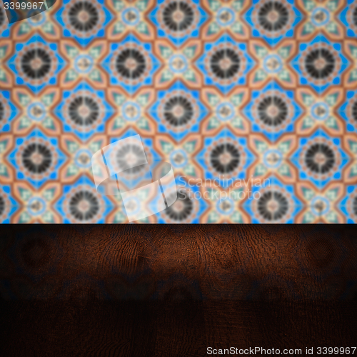 Image of Wood table top and blur vintage ceramic tile pattern wall
