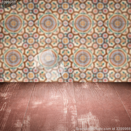 Image of Wood table top and blur vintage ceramic tile pattern wall