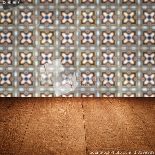 Image of Wood table top and blur vintage ceramic tile pattern wall