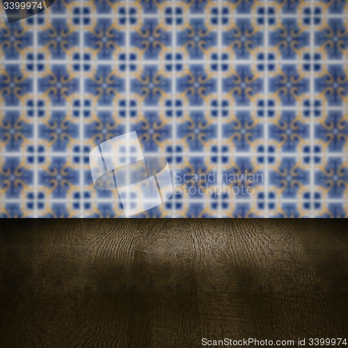 Image of Wood table top and blur vintage ceramic tile pattern wall
