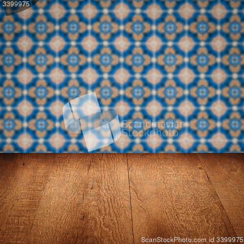 Image of Wood table top and blur vintage ceramic tile pattern wall