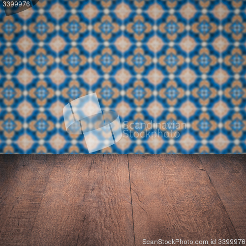 Image of Wood table top and blur vintage ceramic tile pattern wall