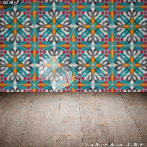 Image of Wood table top and blur vintage ceramic tile pattern wall