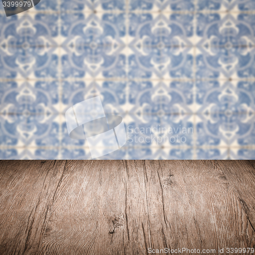 Image of Wood table top and blur vintage ceramic tile pattern wall