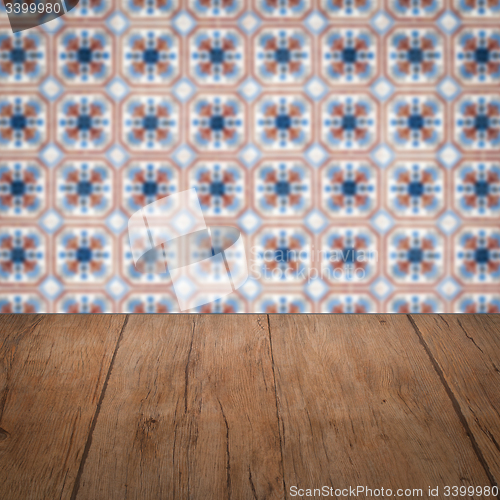 Image of Wood table top and blur vintage ceramic tile pattern wall