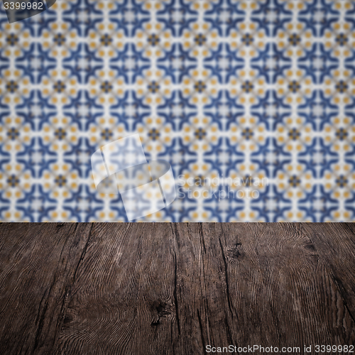 Image of Wood table top and blur vintage ceramic tile pattern wall