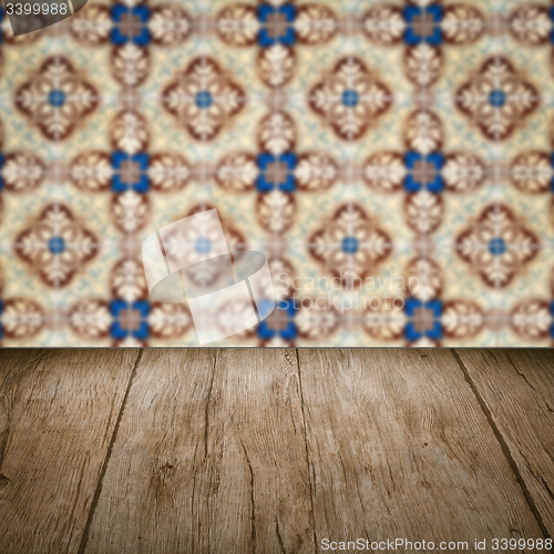 Image of Wood table top and blur vintage ceramic tile pattern wall