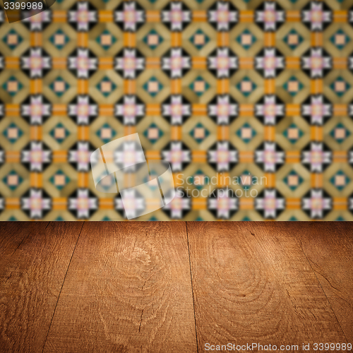 Image of Wood table top and blur vintage ceramic tile pattern wall