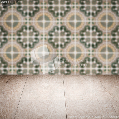 Image of Wood table top and blur vintage ceramic tile pattern wall