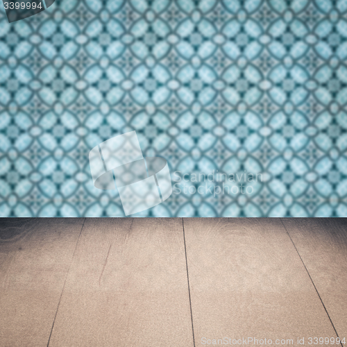 Image of Wood table top and blur vintage ceramic tile pattern wall