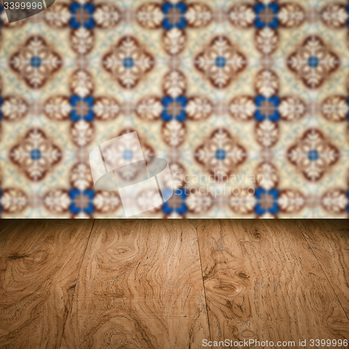 Image of Wood table top and blur vintage ceramic tile pattern wall