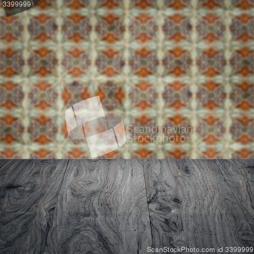 Image of Wood table top and blur vintage ceramic tile pattern wall