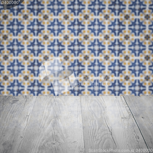 Image of Wood table top and blur vintage ceramic tile pattern wall