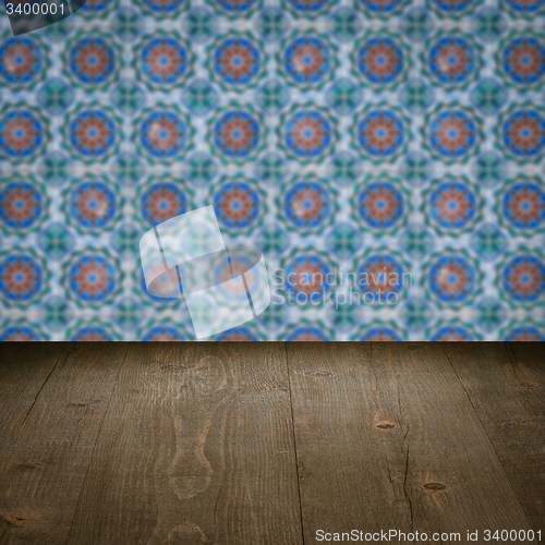Image of Wood table top and blur vintage ceramic tile pattern wall