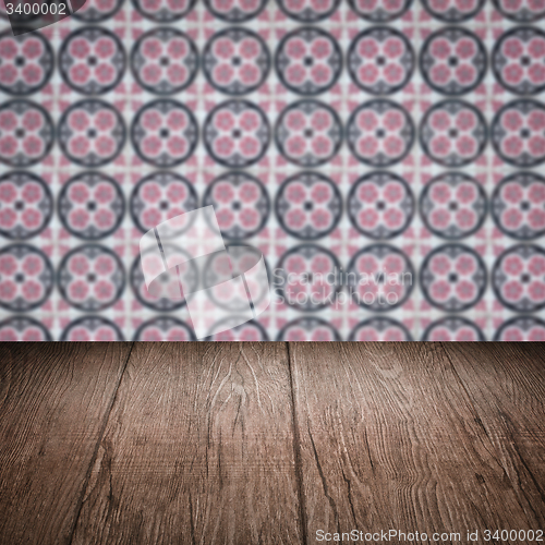 Image of Wood table top and blur vintage ceramic tile pattern wall