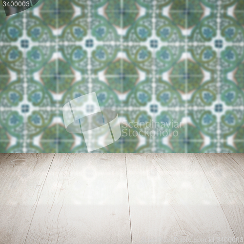 Image of Wood table top and blur vintage ceramic tile pattern wall