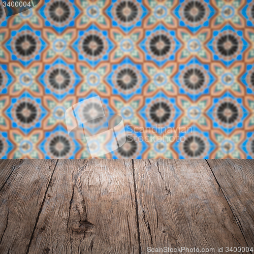Image of Wood table top and blur vintage ceramic tile pattern wall