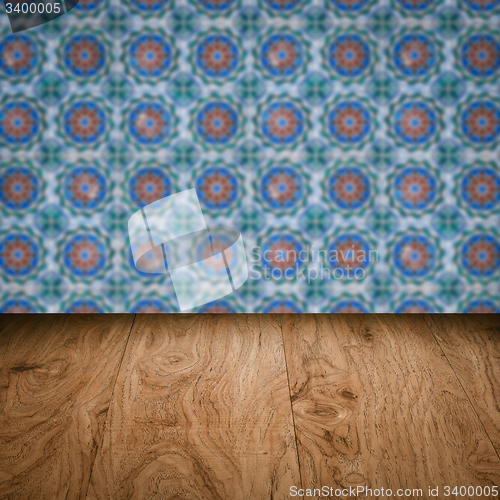 Image of Wood table top and blur vintage ceramic tile pattern wall