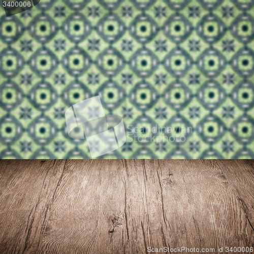 Image of Wood table top and blur vintage ceramic tile pattern wall
