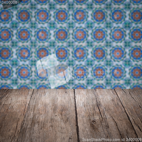 Image of Wood table top and blur vintage ceramic tile pattern wall