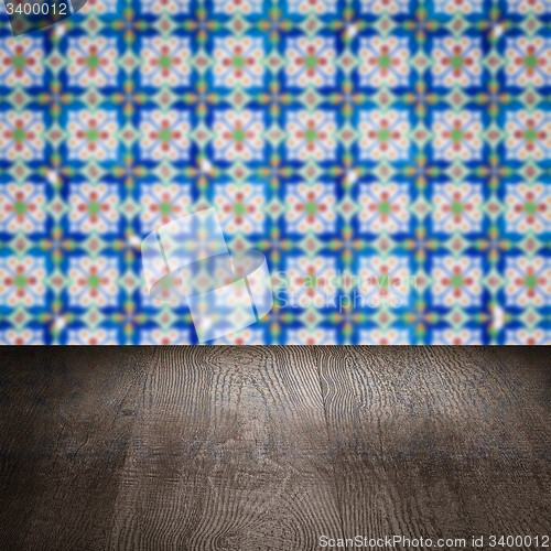 Image of Wood table top and blur vintage ceramic tile pattern wall