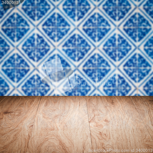 Image of Wood table top and blur vintage ceramic tile pattern wall