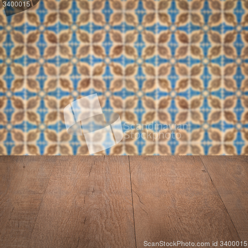 Image of Wood table top and blur vintage ceramic tile pattern wall