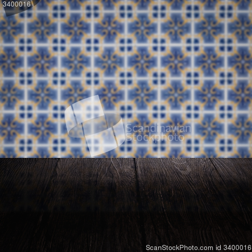 Image of Wood table top and blur vintage ceramic tile pattern wall