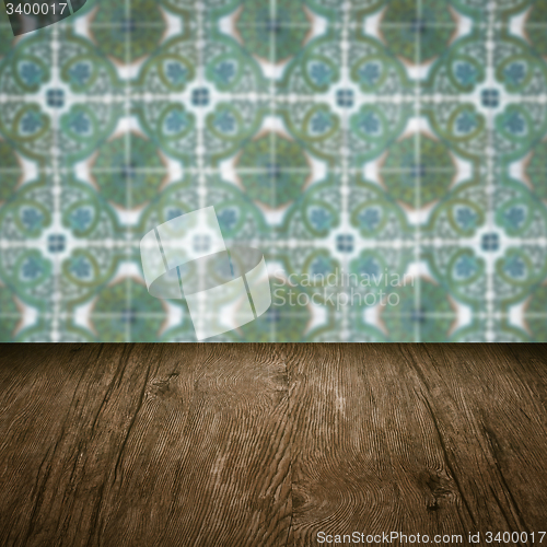 Image of Wood table top and blur vintage ceramic tile pattern wall