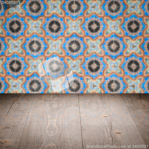 Image of Wood table top and blur vintage ceramic tile pattern wall