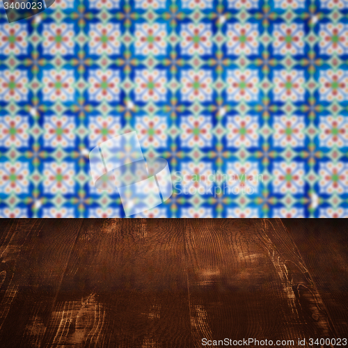 Image of Wood table top and blur vintage ceramic tile pattern wall