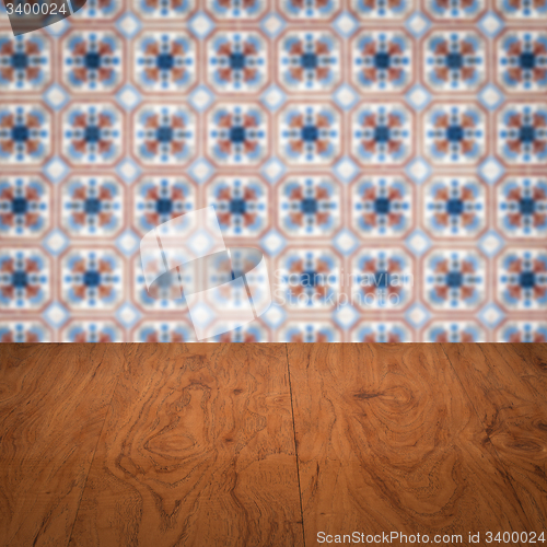 Image of Wood table top and blur vintage ceramic tile pattern wall