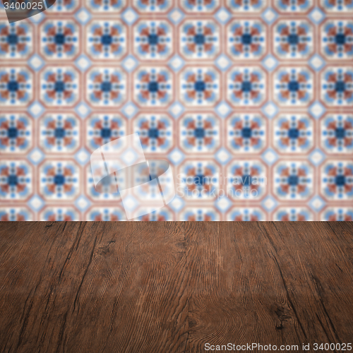 Image of Wood table top and blur vintage ceramic tile pattern wall