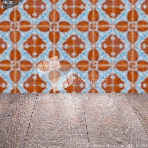 Image of Wood table top and blur vintage ceramic tile pattern wall