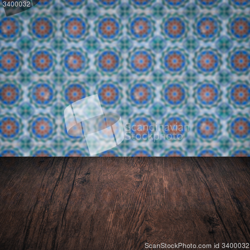 Image of Wood table top and blur vintage ceramic tile pattern wall