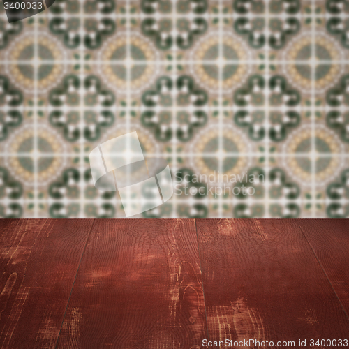 Image of Wood table top and blur vintage ceramic tile pattern wall