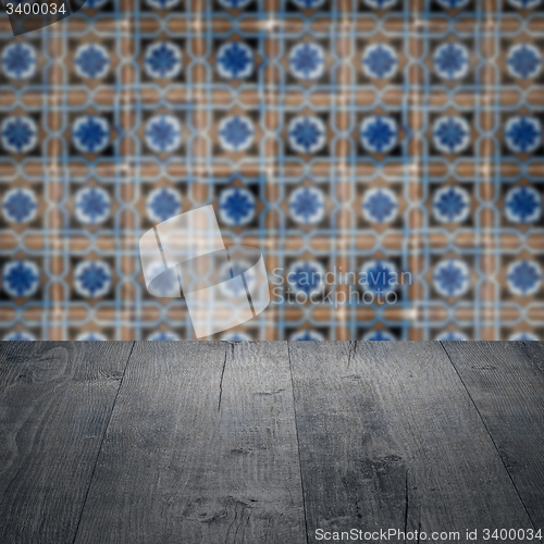 Image of Wood table top and blur vintage ceramic tile pattern wall