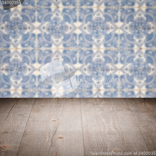 Image of Wood table top and blur vintage ceramic tile pattern wall