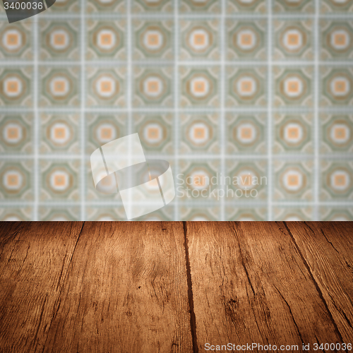 Image of Wood table top and blur vintage ceramic tile pattern wall