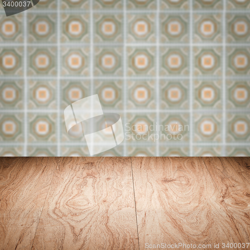 Image of Wood table top and blur vintage ceramic tile pattern wall