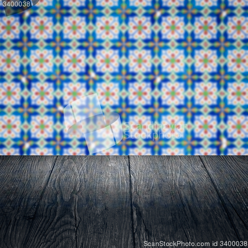 Image of Wood table top and blur vintage ceramic tile pattern wall