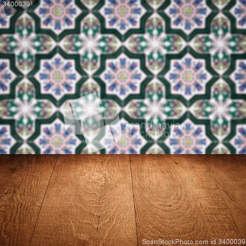 Image of Wood table top and blur vintage ceramic tile pattern wall