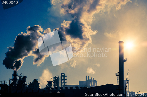 Image of Smoking chimney  at sunset 