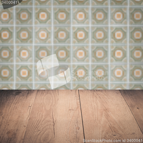 Image of Wood table top and blur vintage ceramic tile pattern wall