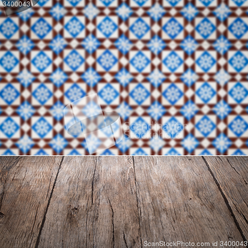 Image of Wood table top and blur vintage ceramic tile pattern wall