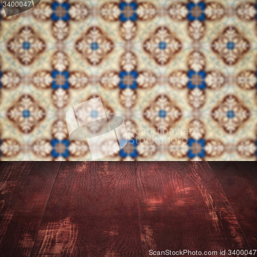 Image of Wood table top and blur vintage ceramic tile pattern wall
