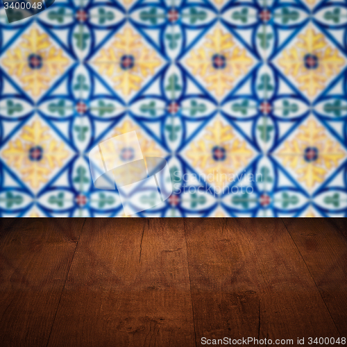 Image of Wood table top and blur vintage ceramic tile pattern wall