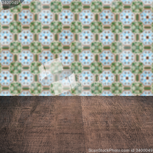 Image of Wood table top and blur vintage ceramic tile pattern wall